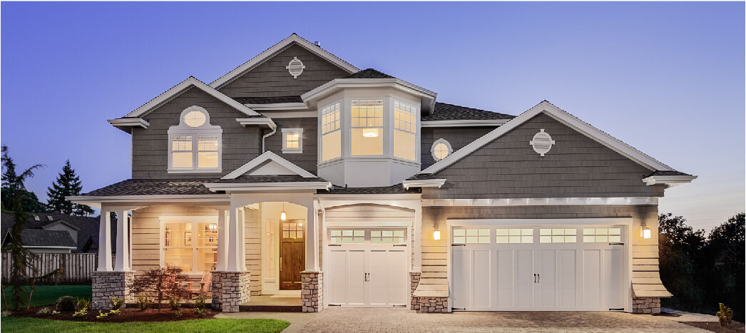 House Exterior at dusk with lights on